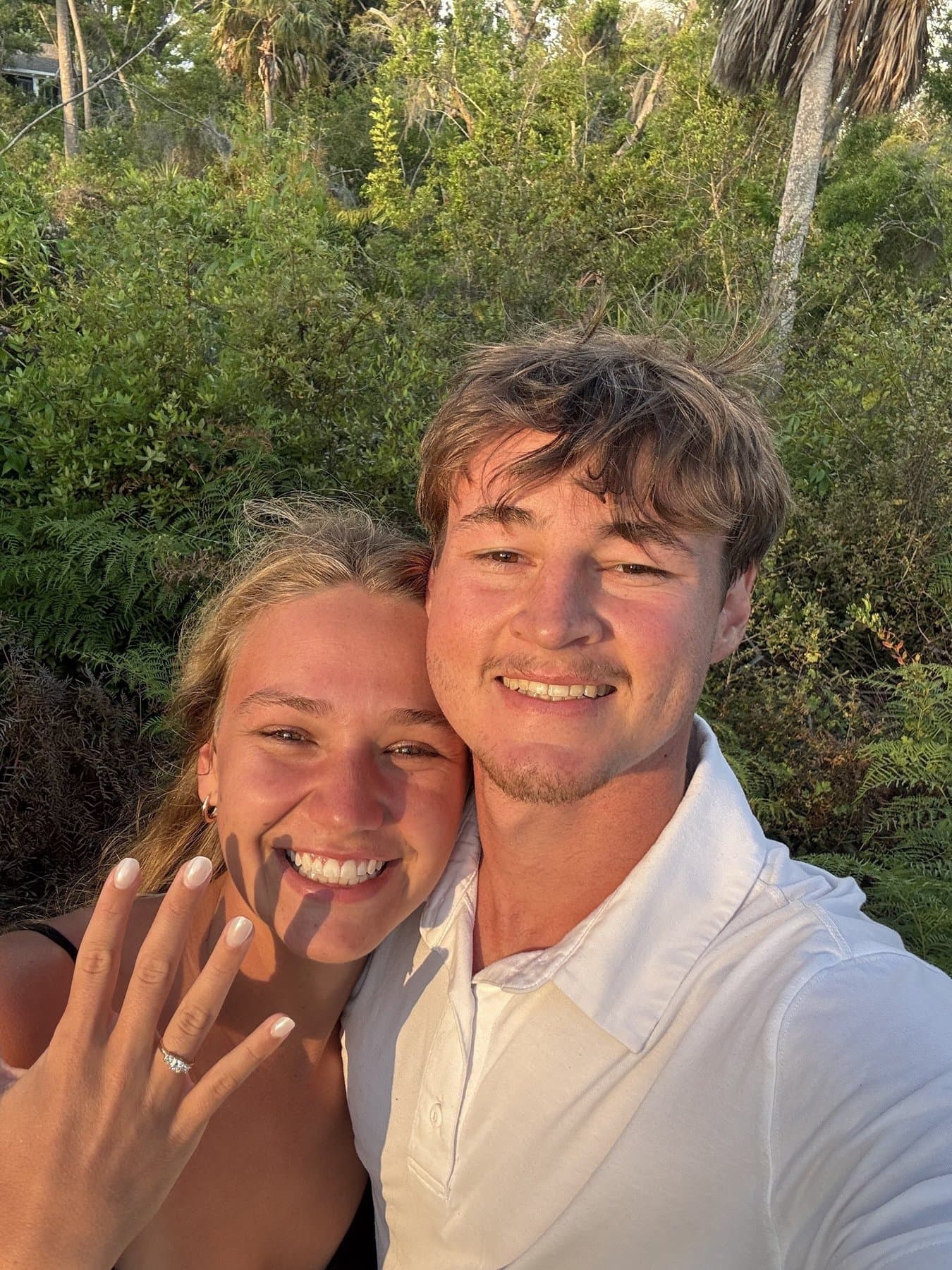 Jonah proposing to Karlie on a forest trail along the west coast beach